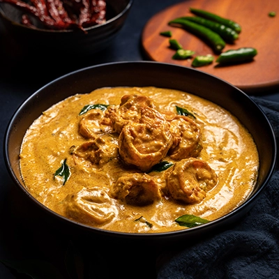 Malabar style chemmeen gravy prepared with coconut spices and fresh seafood in traditional style