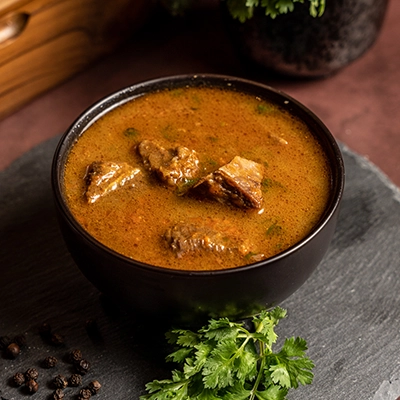 Tangy nelli elumbu rasam prepared with gooseberry and traditional South Indian spice blend
